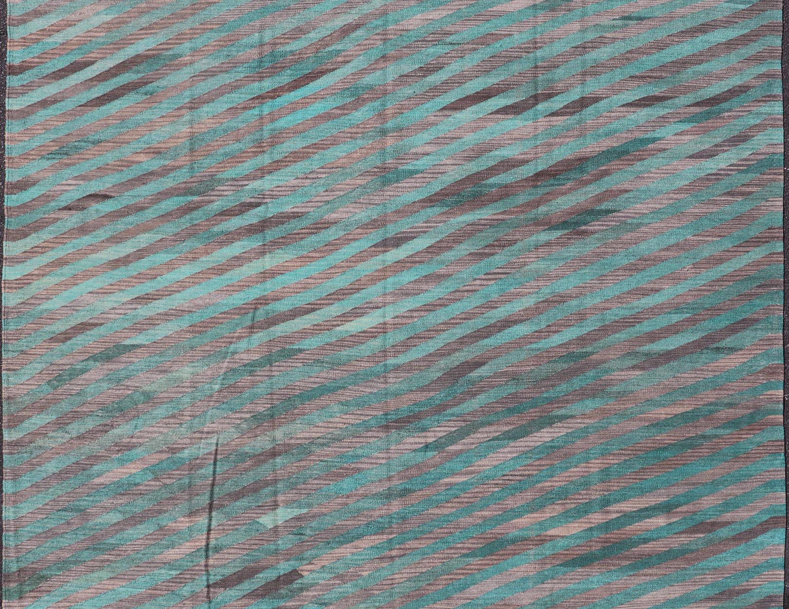 Modern Afghan Hand - Woven Kilim in Wool with Sub - Geometric Slanted Stripe Design This flat - weave kilim has been hand - woven. The rug features a modern slanted stripe design, rendered in green and shades of gray; making this rug a superb fit for a... - Keivan Woven ArtsAFG - 044 - 19676Rug
