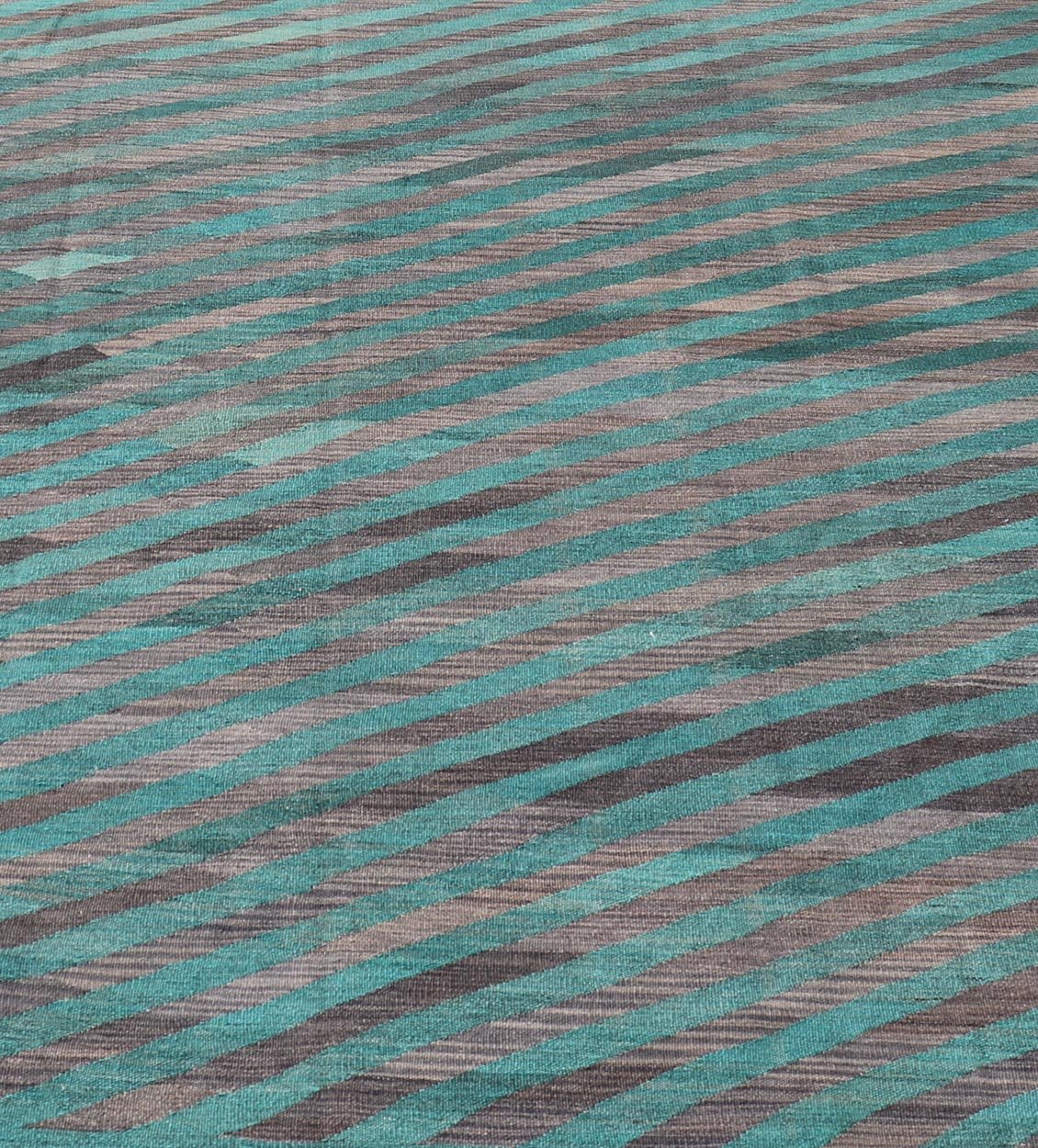 Modern Afghan Hand - Woven Kilim in Wool with Sub - Geometric Slanted Stripe Design This flat - weave kilim has been hand - woven. The rug features a modern slanted stripe design, rendered in green and shades of gray; making this rug a superb fit for a... - Keivan Woven ArtsAFG - 044 - 19676Rug