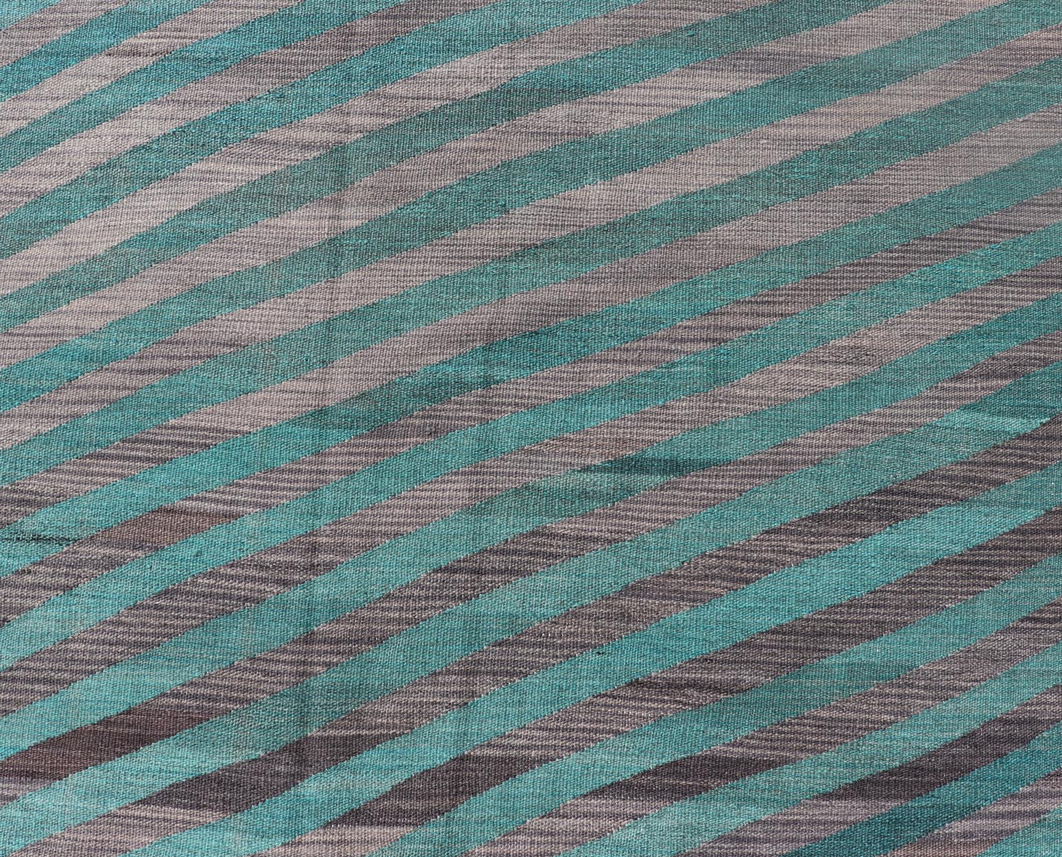 Modern Afghan Hand - Woven Kilim in Wool with Sub - Geometric Slanted Stripe Design This flat - weave kilim has been hand - woven. The rug features a modern slanted stripe design, rendered in green and shades of gray; making this rug a superb fit for a... - Keivan Woven ArtsAFG - 044 - 19676Rug