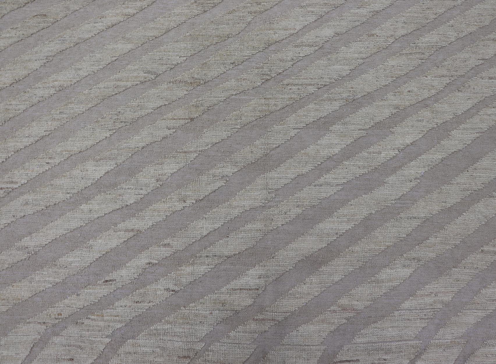 Modern Rug in Wool with Sub - Geometric Slanted Linear Design in Cream and Taupe This modern casual tribal rug has been hand - knotted in wool. The rug features a modern sub - geometric slanted linear design, rendered in creams tones; making this rug ... - Keivan Woven ArtsAFG - 41009 - 19808Rug