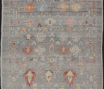 Modern Casual Afghan Hand - Knotted Wool Rug in Taupe Measures: 4'5 x 6'3 This charismatic piece holds much personality in the all - over design of motifs. The tribal - like motifs are rendered in red, beige, pink, blue and small accents of ap... - Keivan Woven ArtsAFG - 43425 - 20253Rug