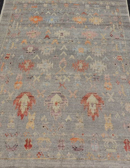 Modern Casual Afghan Hand - Knotted Wool Rug in Taupe Measures: 4'5 x 6'3 This charismatic piece holds much personality in the all - over design of motifs. The tribal - like motifs are rendered in red, beige, pink, blue and small accents of ap... - Keivan Woven ArtsAFG - 43425 - 20253Rug