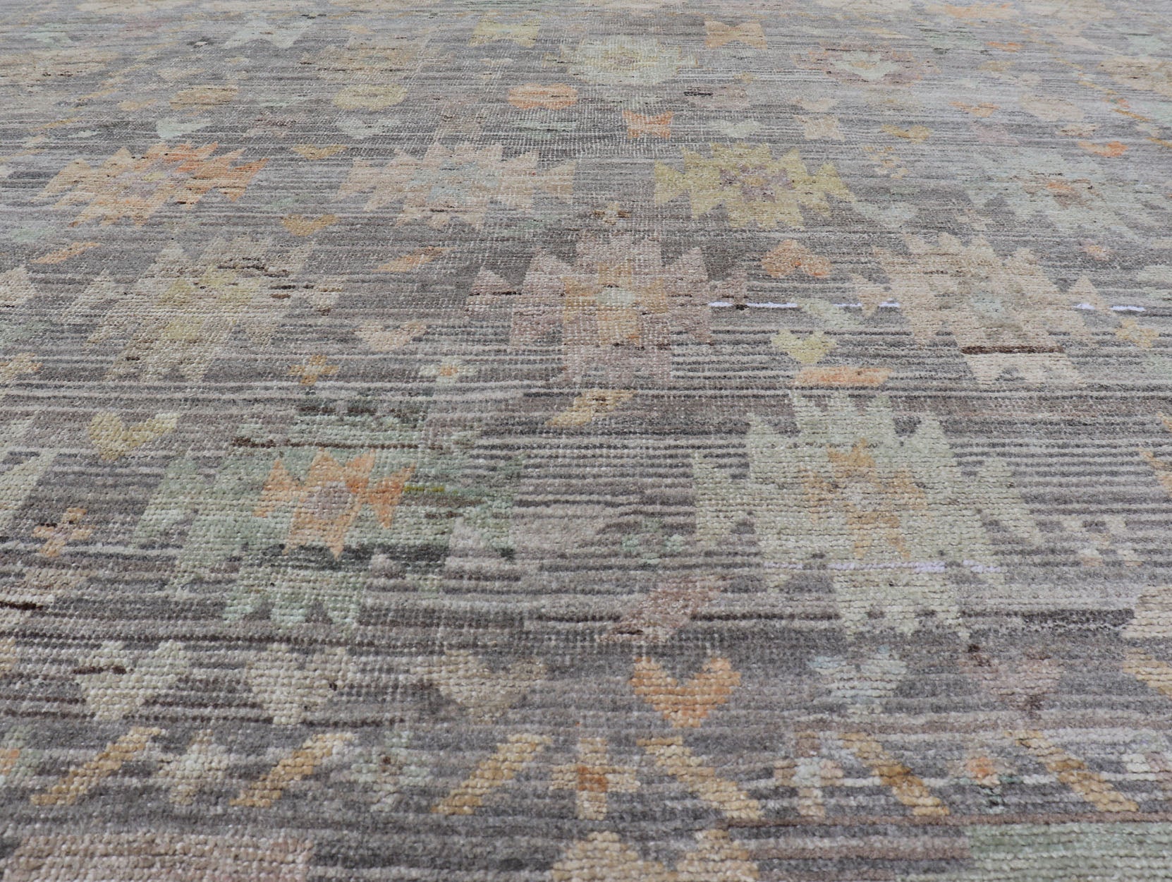 Modern Afghan Tribal Motif Designed Rug in Muted Tones and A Gray Background Measures 7'2 x 8'4 This modern area rug was hand - knotted in Afghanistan during the 2020's. This modern rug does feature a border of modest floral motifs. The gr... - Keivan Woven ArtsAFGC - 39487 - 18565Rug