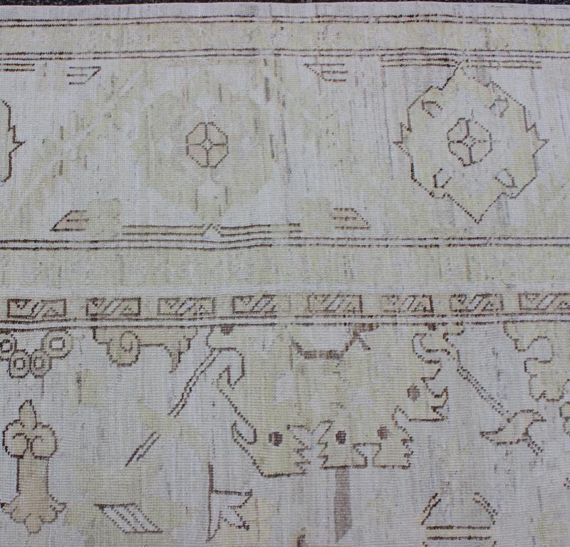 This Afghan made fine rug rug features a transitional design of stylized motifs in the central field, which are flanked by a repeating pattern in the border. The entirety of the piece is rendered in light tones, which makes it a versatile rug, well - sui... - Keivan Woven ArtsAIA - 151 - 6422Rug