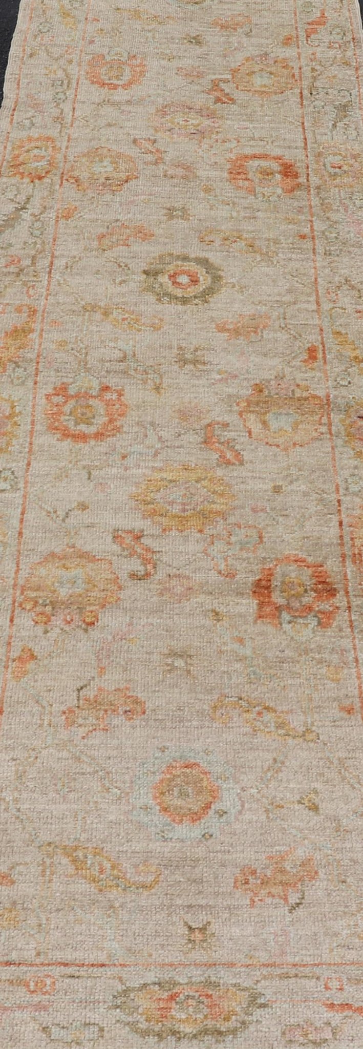 Angora Turkish Oushak Floral Runner in Cream with Pops of Orange, Green and Blue This angora Oushak is unique with is creamy background, to the floral like design rendered in coral, tangerine, forest green, salmon, and hints of sky blue. The bor... - Keivan Woven ArtsAN - 149531 - 19947Rug