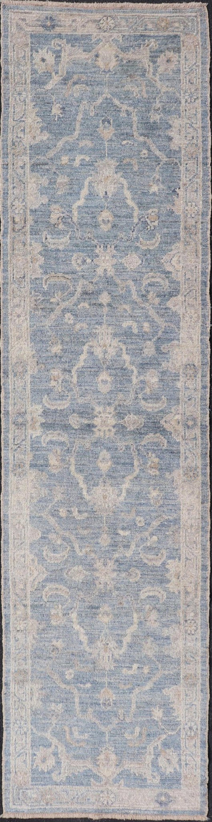 Angora Turkish Oushak Runner with Floral Design and Medium Blue and Gray Border This Oushak Runner is rendered in a medium blue background and a light gray border. The design is an arabesque - like floral pattern, cased within a banded sub - floral ... - Keivan Woven ArtsAN - 149801 - 19935Rug