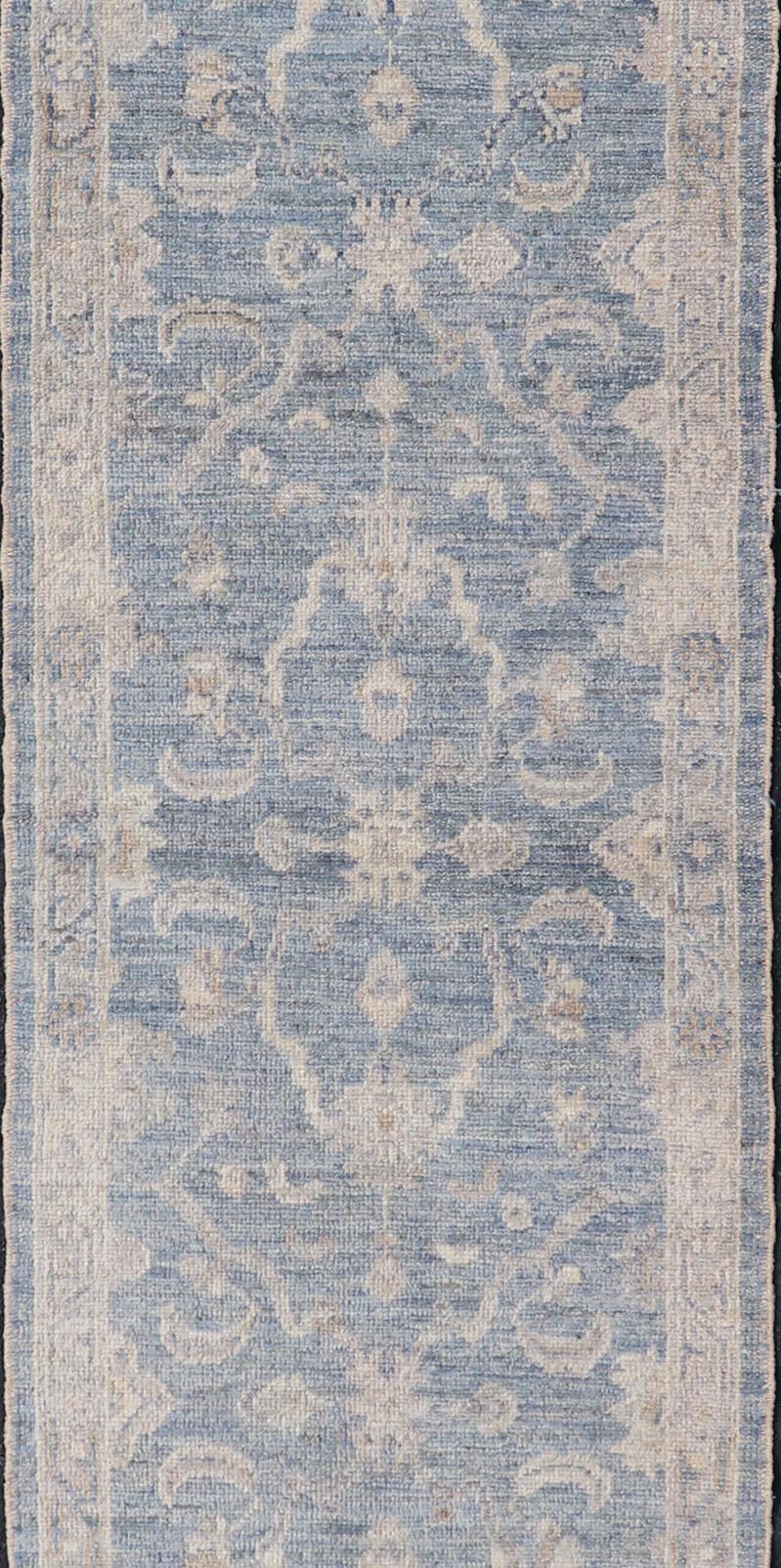 Angora Turkish Oushak Runner with Floral Design and Medium Blue and Gray Border This Oushak Runner is rendered in a medium blue background and a light gray border. The design is an arabesque - like floral pattern, cased within a banded sub - floral ... - Keivan Woven ArtsAN - 149801 - 19935Rug