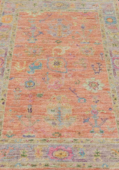 Hand Knotted Turkish Floral Oushak with Orange Background and Lilac Border This very unique piece has a wide array of bright colors, starting with a faded orange background and a light lilac border, showcasing fuchsia, electric blue, violet, or... - Keivan Woven ArtsAN - 149896 - 19941Rug