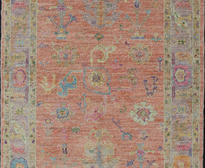 Hand Knotted Turkish Floral Oushak with Orange Background and Lilac Border This very unique piece has a wide array of bright colors, starting with a faded orange background and a light lilac border, showcasing fuchsia, electric blue, violet, or... - Keivan Woven ArtsAN - 149896 - 19941Rug