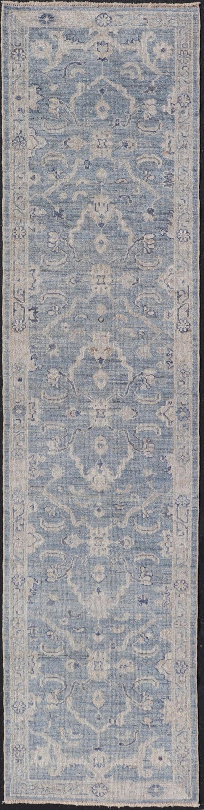 This Oushak Runner is rendered in a medium blue background and a light gray border. The design is an arabesque - like floral pattern, cased within a banded sub - floral border in light gray. Measures: 2'7 x 11'8 Angora Turkish Oushak Runner wit... - Keivan Woven ArtsAN - 151167 - 21391Rug