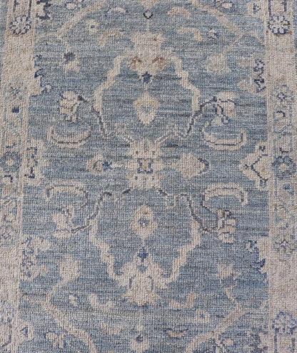 This Oushak Runner is rendered in a medium blue background and a light gray border. The design is an arabesque - like floral pattern, cased within a banded sub - floral border in light gray. Measures: 2'7 x 11'8 Angora Turkish Oushak Runner wit... - Keivan Woven ArtsAN - 151167 - 21391Rug