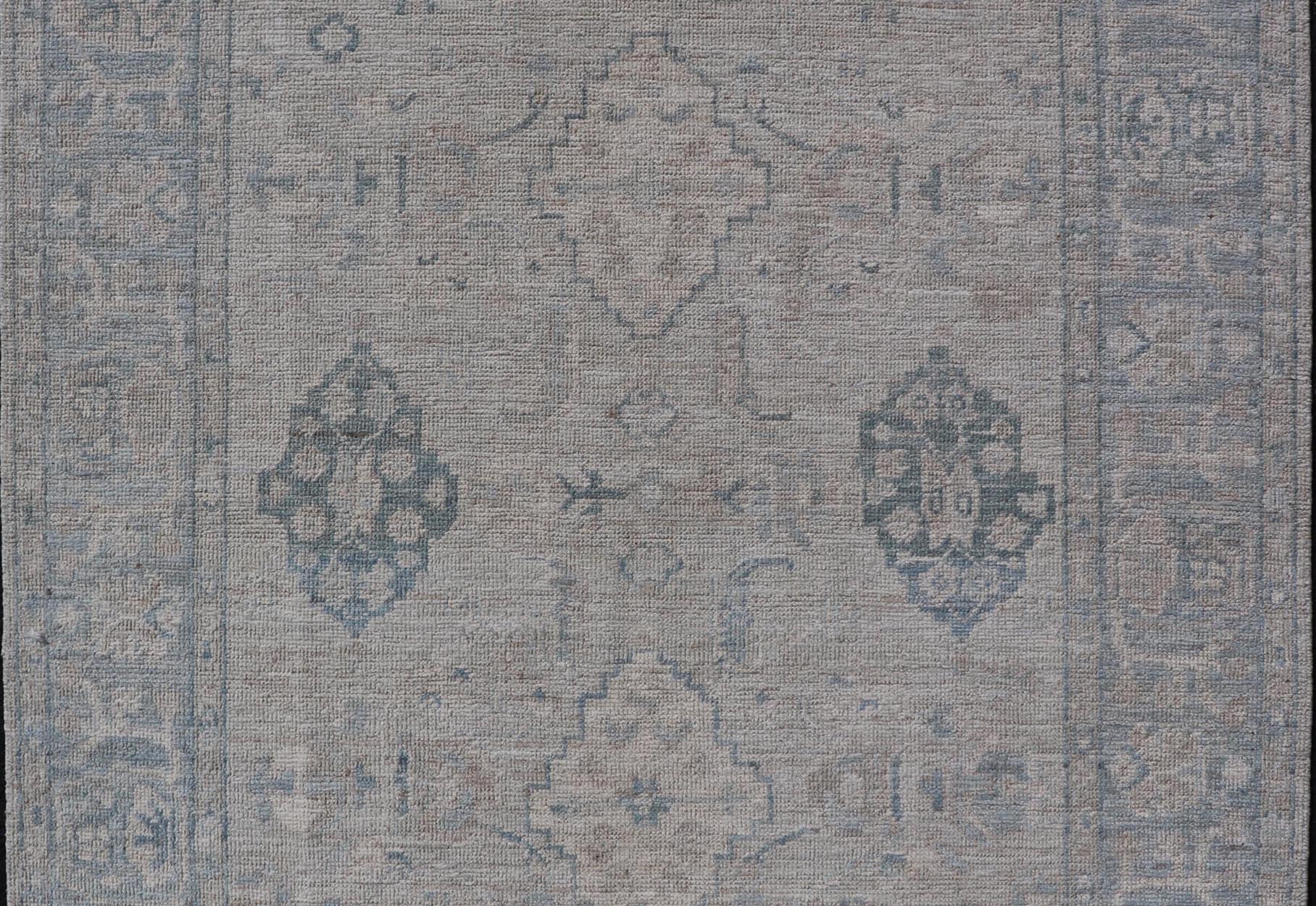 Hand - Knotted Oushak with A Light Blue Background and Tribal Motifs. Keivan Woven Arts; rug AWR - 10729 Country of Origin: Afghanistan Type: Oushak Design: Floral, All - Over Abstract - Tribal Measures: 4'0 x 5'4 This Oushak presents centered motif di... - Keivan Woven ArtsAWR - 10729 - 21627Rug