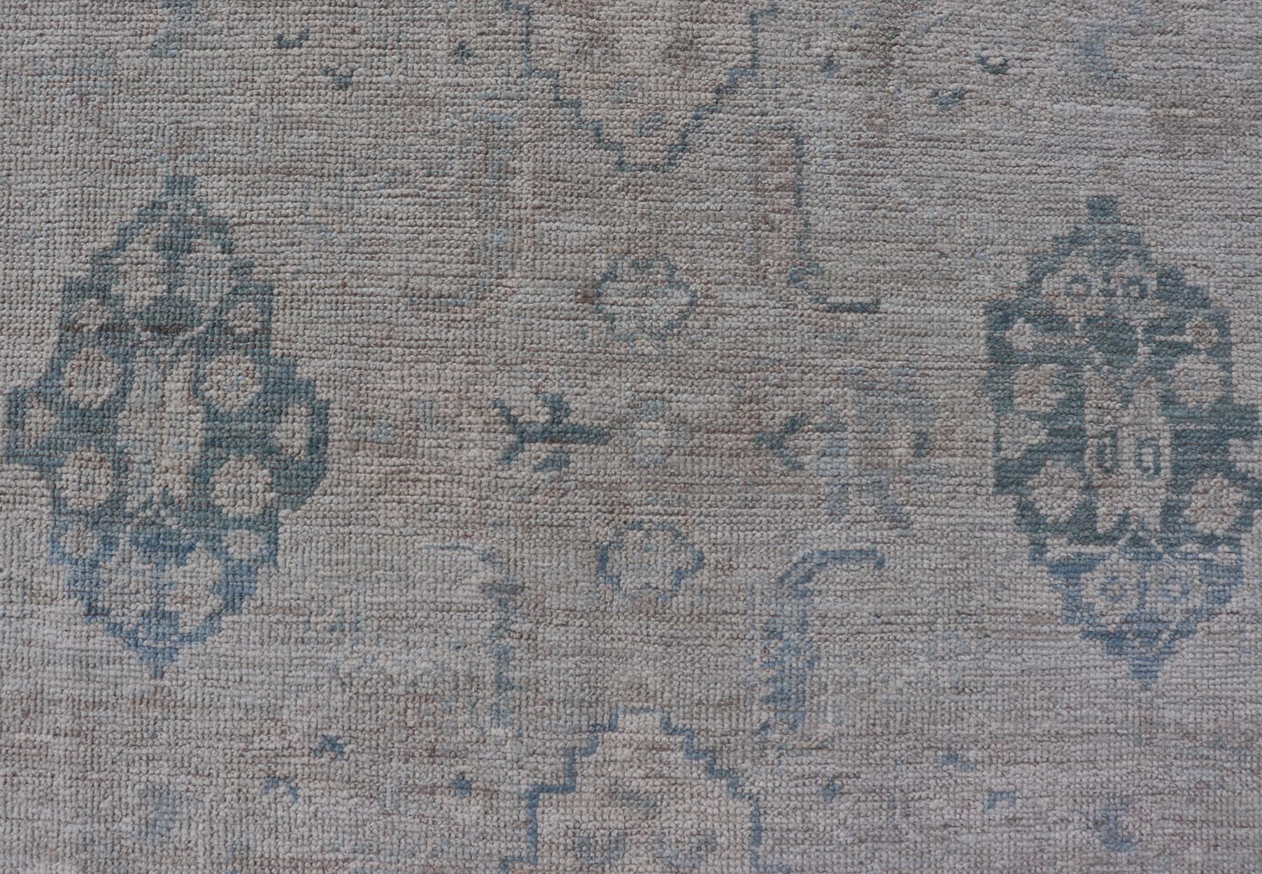 Hand - Knotted Oushak with A Light Blue Background and Tribal Motifs. Keivan Woven Arts; rug AWR - 10729 Country of Origin: Afghanistan Type: Oushak Design: Floral, All - Over Abstract - Tribal Measures: 4'0 x 5'4 This Oushak presents centered motif di... - Keivan Woven ArtsAWR - 10729 - 21627Rug