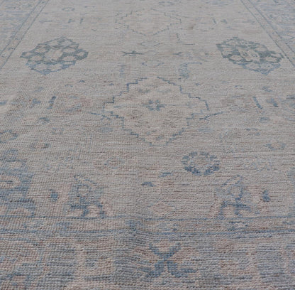 Hand - Knotted Oushak with A Light Blue Background and Tribal Motifs. Keivan Woven Arts; rug AWR - 10729 Country of Origin: Afghanistan Type: Oushak Design: Floral, All - Over Abstract - Tribal Measures: 4'0 x 5'4 This Oushak presents centered motif di... - Keivan Woven ArtsAWR - 10729 - 21627Rug