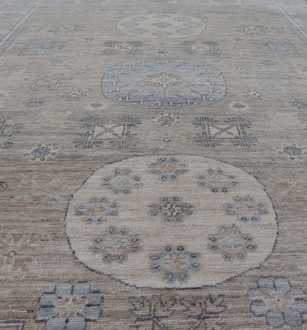 Measures: 6'0 x 9'1 Khotan Design Rug with Circular Medallion in Light Green, Light Blue, and Cream. Keivan Woven Arts , rug/AWR - 12172 country of origin / type: Afghanistan / Khotan. This Khotan features a geometric all - over design flanked b... - Keivan Woven ArtsAWR - 12172 - 23217