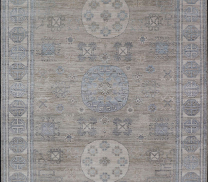 Measures: 6'0 x 9'1 Khotan Design Rug with Circular Medallion in Light Green, Light Blue, and Cream. Keivan Woven Arts , rug/AWR - 12172 country of origin / type: Afghanistan / Khotan. This Khotan features a geometric all - over design flanked b... - Keivan Woven ArtsAWR - 12172 - 23217