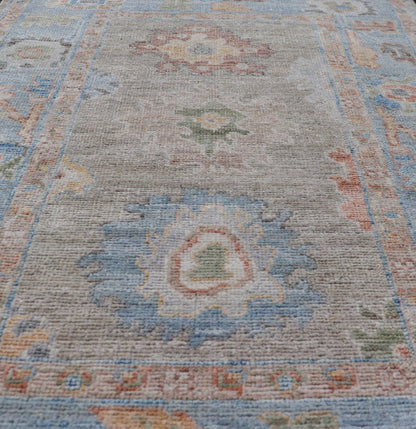 Measures: 2'7 x 4'0 Modern Floral Oushak With Sandy - Brown Background and A Sky Blue Border. Keivan Woven Arts; rug AWR - 12378 Country of Origin: Afghanistan Type: Oushak Design: Floral, Arabesque, All - Over. This piece gives a modern vibrancy... - Keivan Woven ArtsAWR - 12378 - 23258Rug