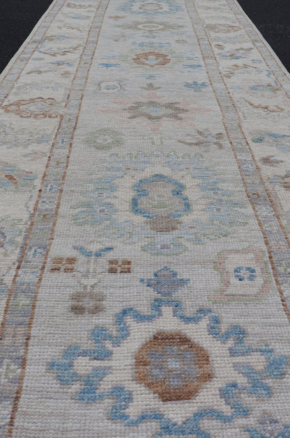 Measures: 3'1 x 12'3 Modern Oushak Runner on Light Cream Field and Colorful Motifs Of Blue & Green. Keivan Woven Arts; rug AWR - 12500 Country of Origin: Afghanistan Type: Oushak Design: Floral, All - Over Floral 21st Century This Oushak runner... - Keivan Woven ArtsAWR - 12500 - 23300Rug