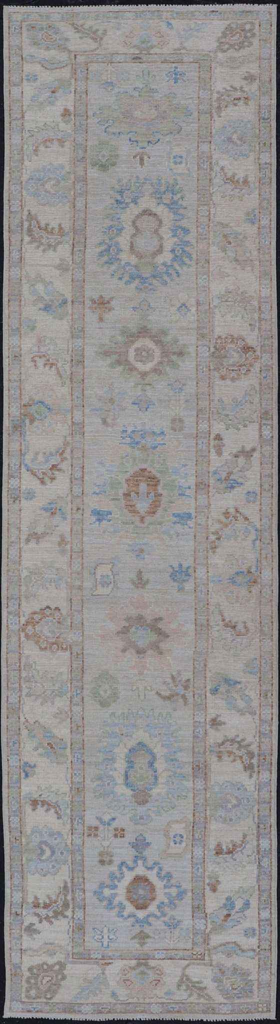 Measures: 3'1 x 12'3 Modern Oushak Runner on Light Cream Field and Colorful Motifs Of Blue & Green. Keivan Woven Arts; rug AWR - 12500 Country of Origin: Afghanistan Type: Oushak Design: Floral, All - Over Floral 21st Century This Oushak runner... - Keivan Woven ArtsAWR - 12500 - 23300Rug