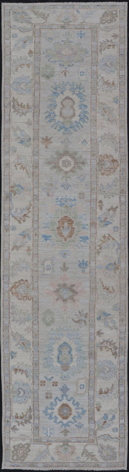 Measures: 3'1 x 12'3 Modern Oushak Runner on Light Cream Field and Colorful Motifs Of Blue & Green. Keivan Woven Arts; rug AWR - 12500 Country of Origin: Afghanistan Type: Oushak Design: Floral, All - Over Floral 21st Century This Oushak runner... - Keivan Woven ArtsAWR - 12500 - 23300Rug