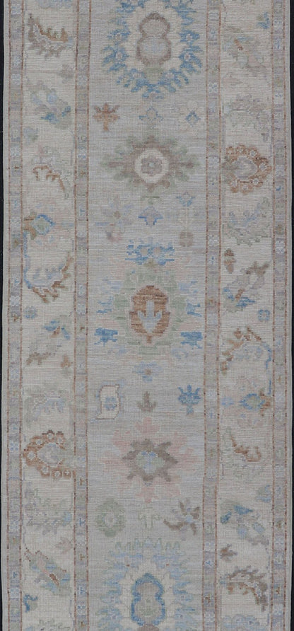 Measures: 3'1 x 12'3 Modern Oushak Runner on Light Cream Field and Colorful Motifs Of Blue & Green. Keivan Woven Arts; rug AWR - 12500 Country of Origin: Afghanistan Type: Oushak Design: Floral, All - Over Floral 21st Century This Oushak runner... - Keivan Woven ArtsAWR - 12500 - 23300Rug