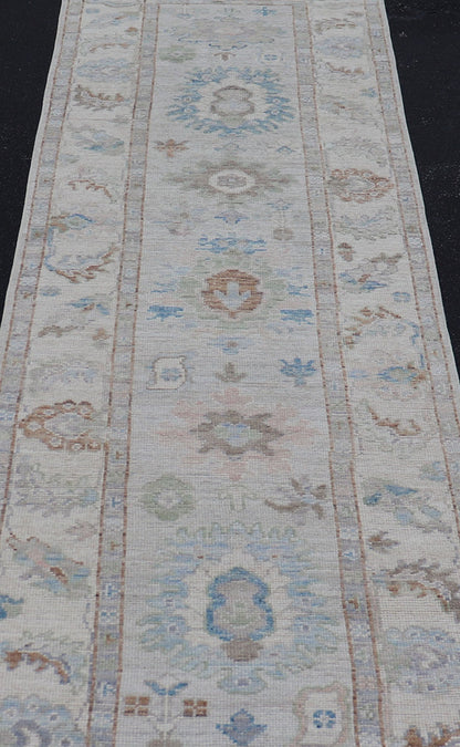 Measures: 3'1 x 12'3 Modern Oushak Runner on Light Cream Field and Colorful Motifs Of Blue & Green. Keivan Woven Arts; rug AWR - 12500 Country of Origin: Afghanistan Type: Oushak Design: Floral, All - Over Floral 21st Century This Oushak runner... - Keivan Woven ArtsAWR - 12500 - 23300Rug