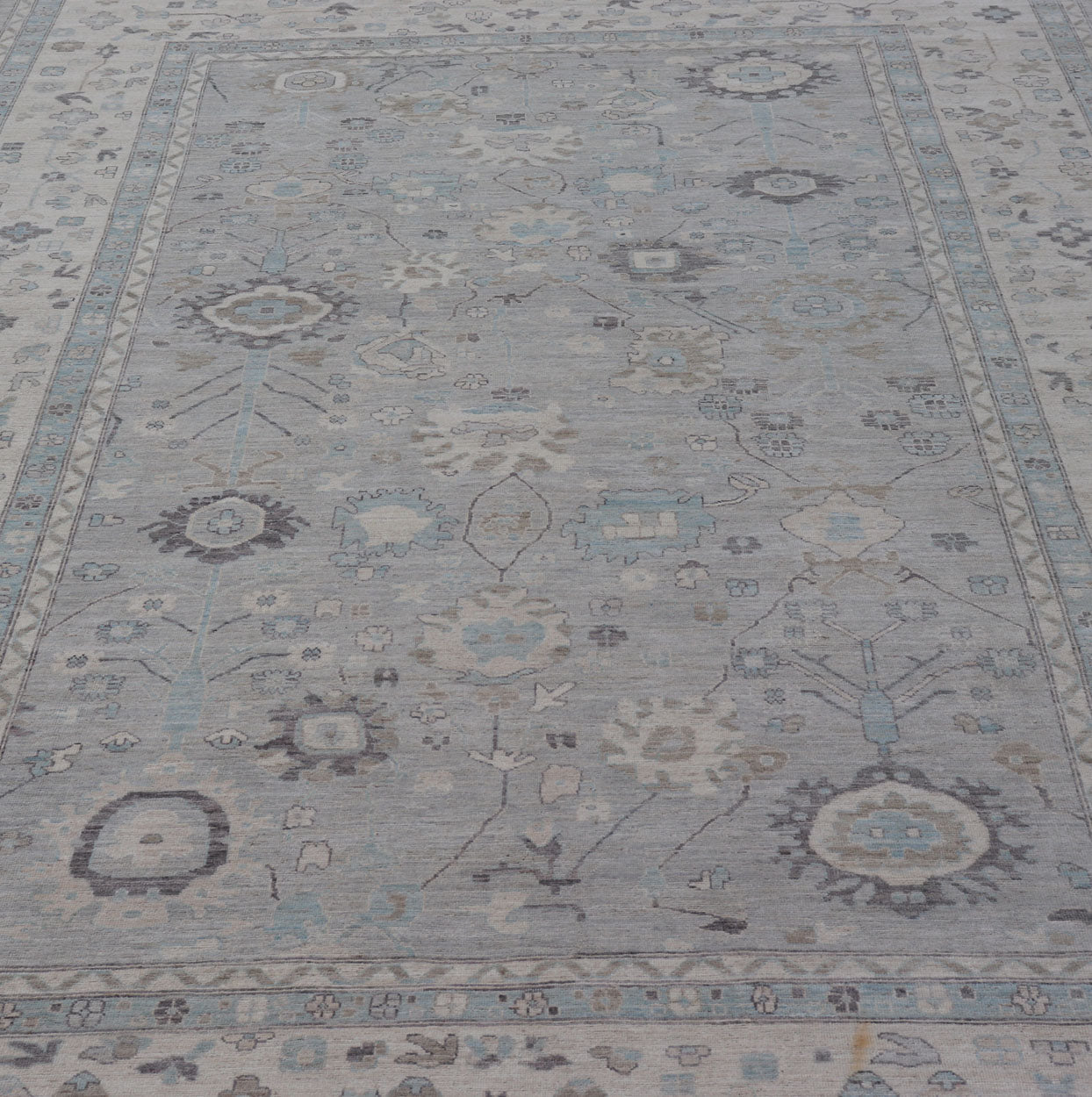 Measures: 13'4 x 19'3 Large Modern Oushak Design in Light Blue, Grey, with Light Cream Background. Keivan Woven Arts; rug AWR - 12521 Country of Origin: Afghanistan Type: Oushak Design: All - Over, Floral. This rustic piece holds charm within a powd... - Keivan Woven ArtsAWR - 12521 - 23402