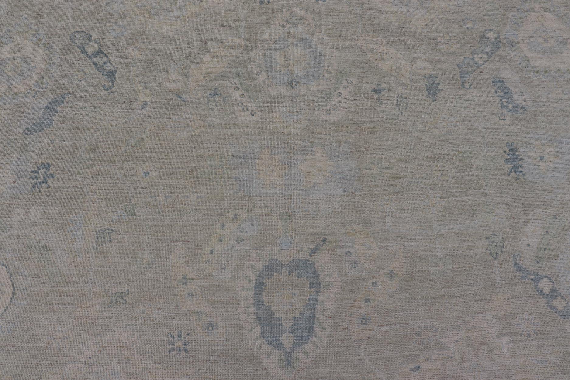 Large Modern Oushak Design in Light Blue, Green, with Light Cream Background. Keivan Woven Arts; rug AWR - 12521 Country of Origin: Afghanistan Type: Oushak Design: All - Over, Floral. Measures: 11'9 x 17'10 This rustic piece holds charm within a po... - Keivan Woven ArtsAWR - 16859 - 24976Rug