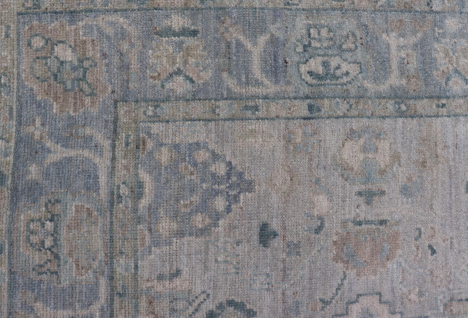 Hand - Knotted Oushak with a Light Blue - Gray Background and Tribal Motifs. Keivan Woven Arts; rug AWR - 16951 Country of Origin: Afghanistan Type: Oushak Design: Floral, All - Over Abstract - Tribal. Measures: 3'10 x 6'0 This Oushak presents centered m... - Keivan Woven ArtsAWR - 16951 - 24786Rug