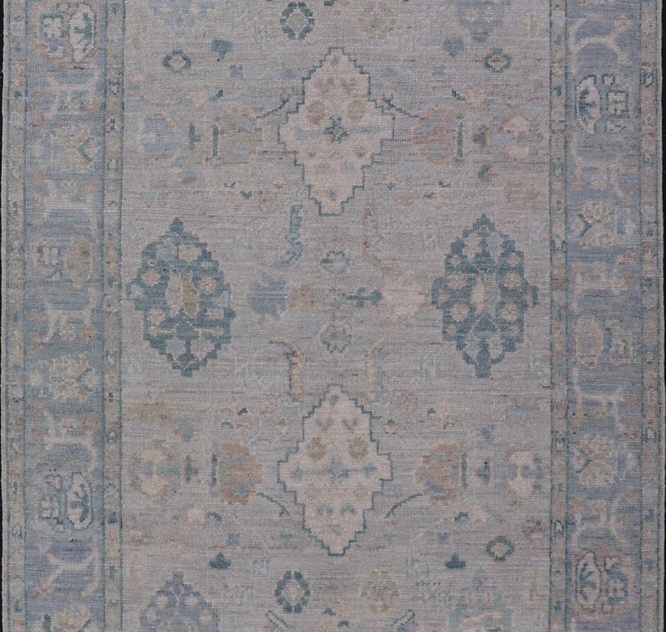 Hand - Knotted Oushak with a Light Blue - Gray Background and Tribal Motifs. Keivan Woven Arts; rug AWR - 16951 Country of Origin: Afghanistan Type: Oushak Design: Floral, All - Over Abstract - Tribal. Measures: 3'10 x 6'0 This Oushak presents centered m... - Keivan Woven ArtsAWR - 16951 - 24786Rug