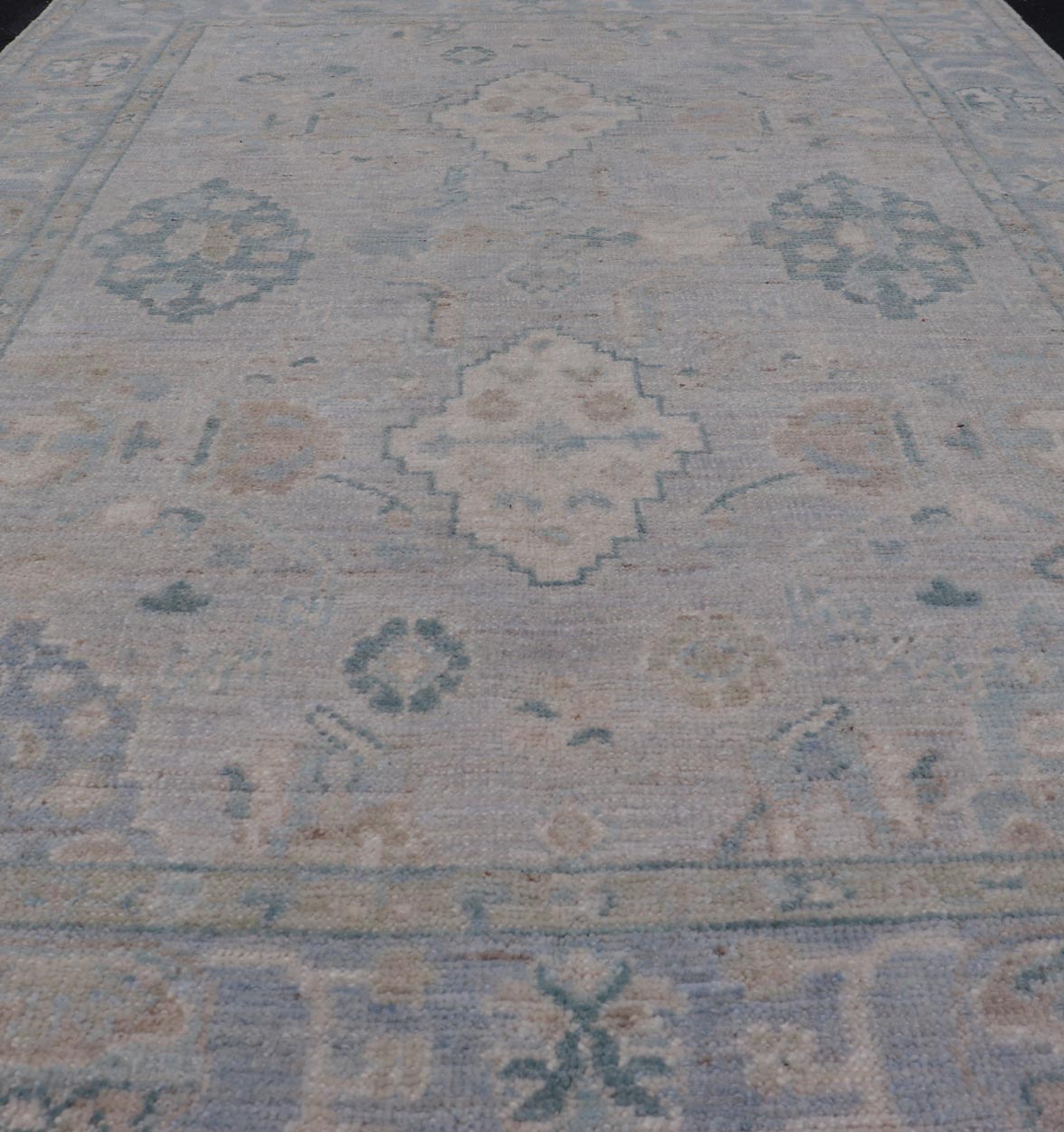 Hand - Knotted Oushak with a Light Blue - Gray Background and Tribal Motifs. Keivan Woven Arts; rug AWR - 16951 Country of Origin: Afghanistan Type: Oushak Design: Floral, All - Over Abstract - Tribal. Measures: 3'10 x 6'0 This Oushak presents centered m... - Keivan Woven ArtsAWR - 16951 - 24786Rug