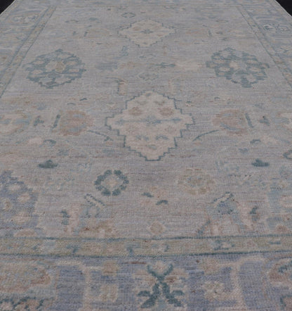Hand - Knotted Oushak with a Light Blue - Gray Background and Tribal Motifs. Keivan Woven Arts; rug AWR - 16951 Country of Origin: Afghanistan Type: Oushak Design: Floral, All - Over Abstract - Tribal. Measures: 3'10 x 6'0 This Oushak presents centered m... - Keivan Woven ArtsAWR - 16951 - 24786Rug