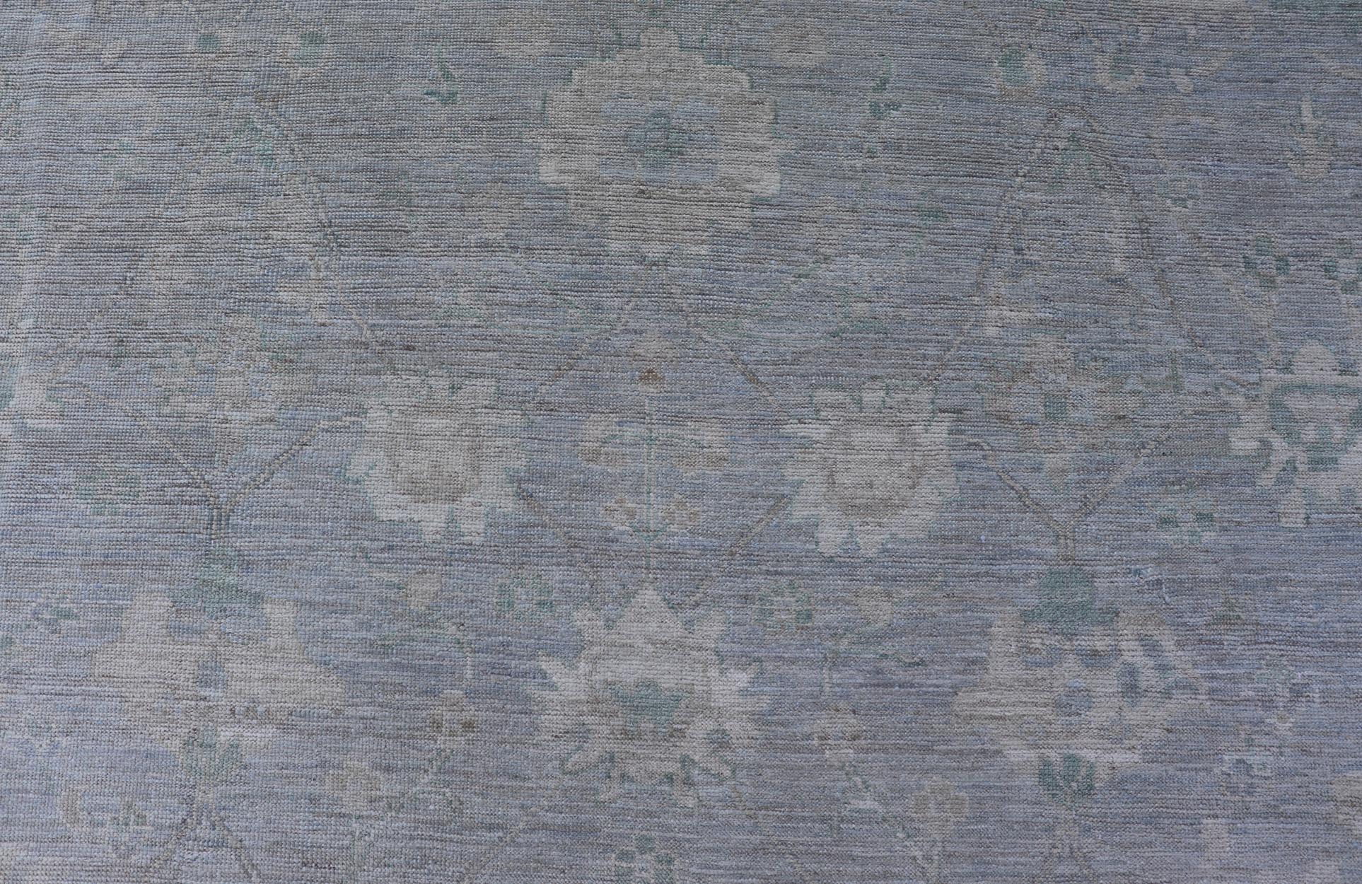 Modern Oushak with Floral Motifs with Cream, Grey, Blue, and Powder Blue. Keivan Woven Arts; rug AWR - 17319 Country of Origin: Afghanistan Type: Oushak Design: Floral, All - Over Abstract - Tribal 21st century. Measures: 9'3 x 11'8 This modern Ousha... - Keivan Woven ArtsAWR - 17319 - 25000Rug