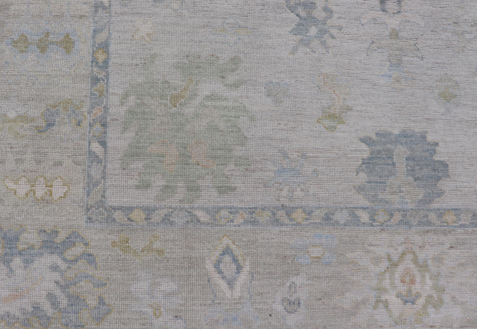 Modern Tribal Oushak with a Cream Border and Light Gray - Blue Background. Country of Origin: Afghanistan; Type: Oushak; Design: Medallion, Tribal Medallion, All - Over; Keivan Woven Arts: rug AWR - 17501. Measures: 8'0 x 10'0 A Oushak featuring all... - Keivan Woven ArtsAWR - 17501 - 24910