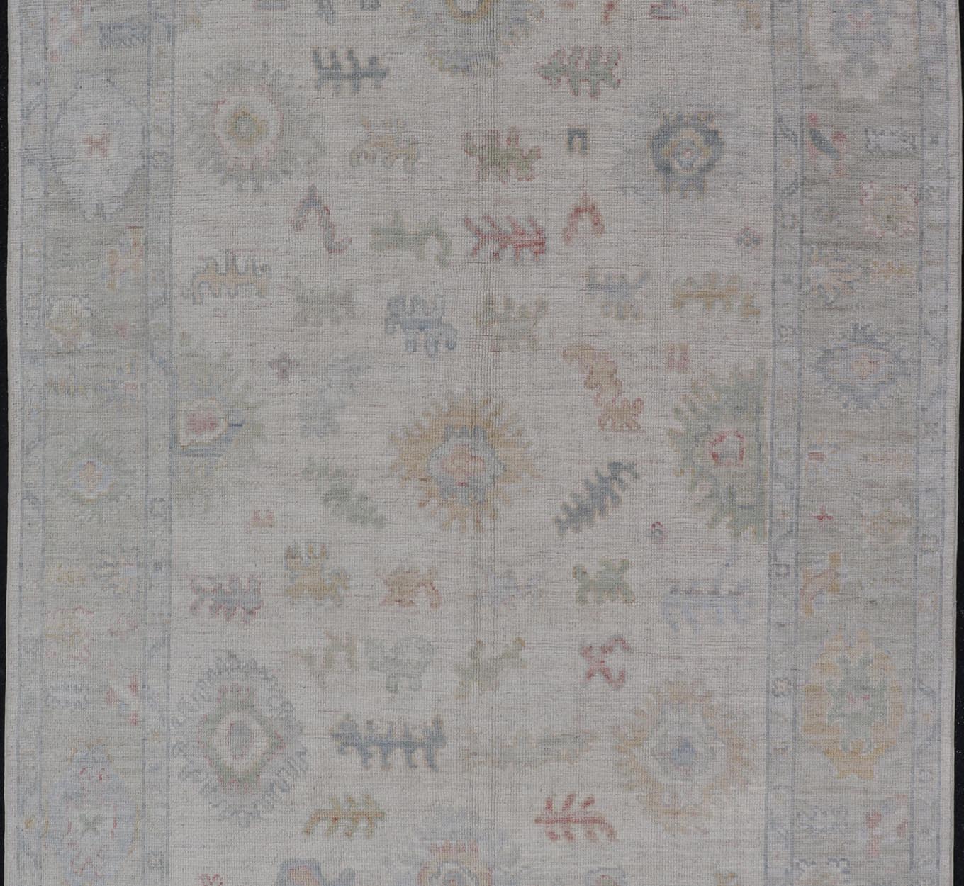 Large Oushak Rug with Floral Motifs & Muted Colorful Tones on Neutral Background. Keivan Woven Arts; rug AWR - 17881 Country of Origin: Afghanistan Type: Oushak Design. Measures: 5'10 x 9'1 This large Oushak has a border and background that are co... - Keivan Woven ArtsAWR - 17881 - 24916Rug