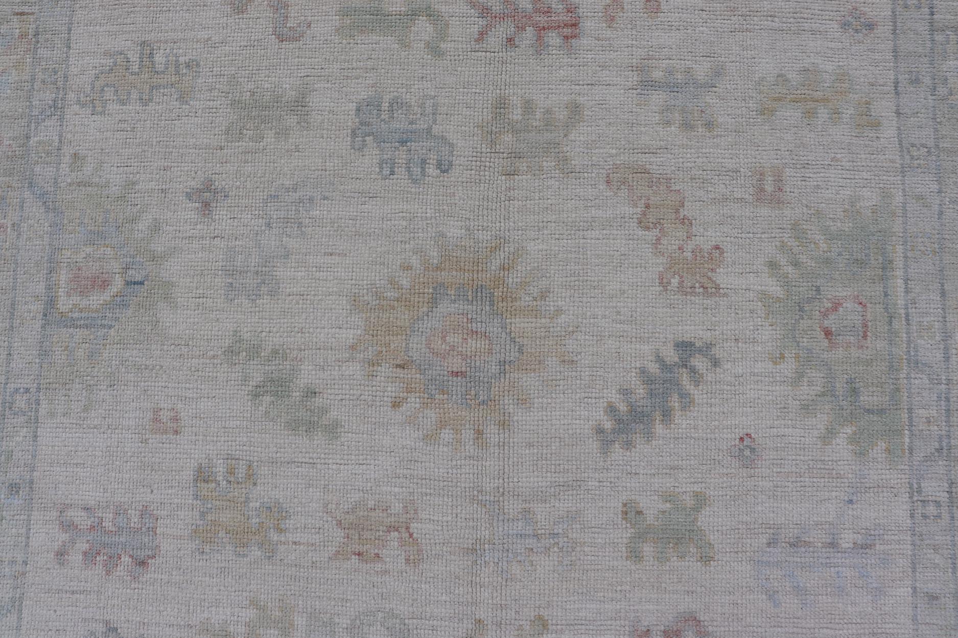 Large Oushak Rug with Floral Motifs & Muted Colorful Tones on Neutral Background. Keivan Woven Arts; rug AWR - 17881 Country of Origin: Afghanistan Type: Oushak Design. Measures: 5'10 x 9'1 This large Oushak has a border and background that are co... - Keivan Woven ArtsAWR - 17881 - 24916Rug