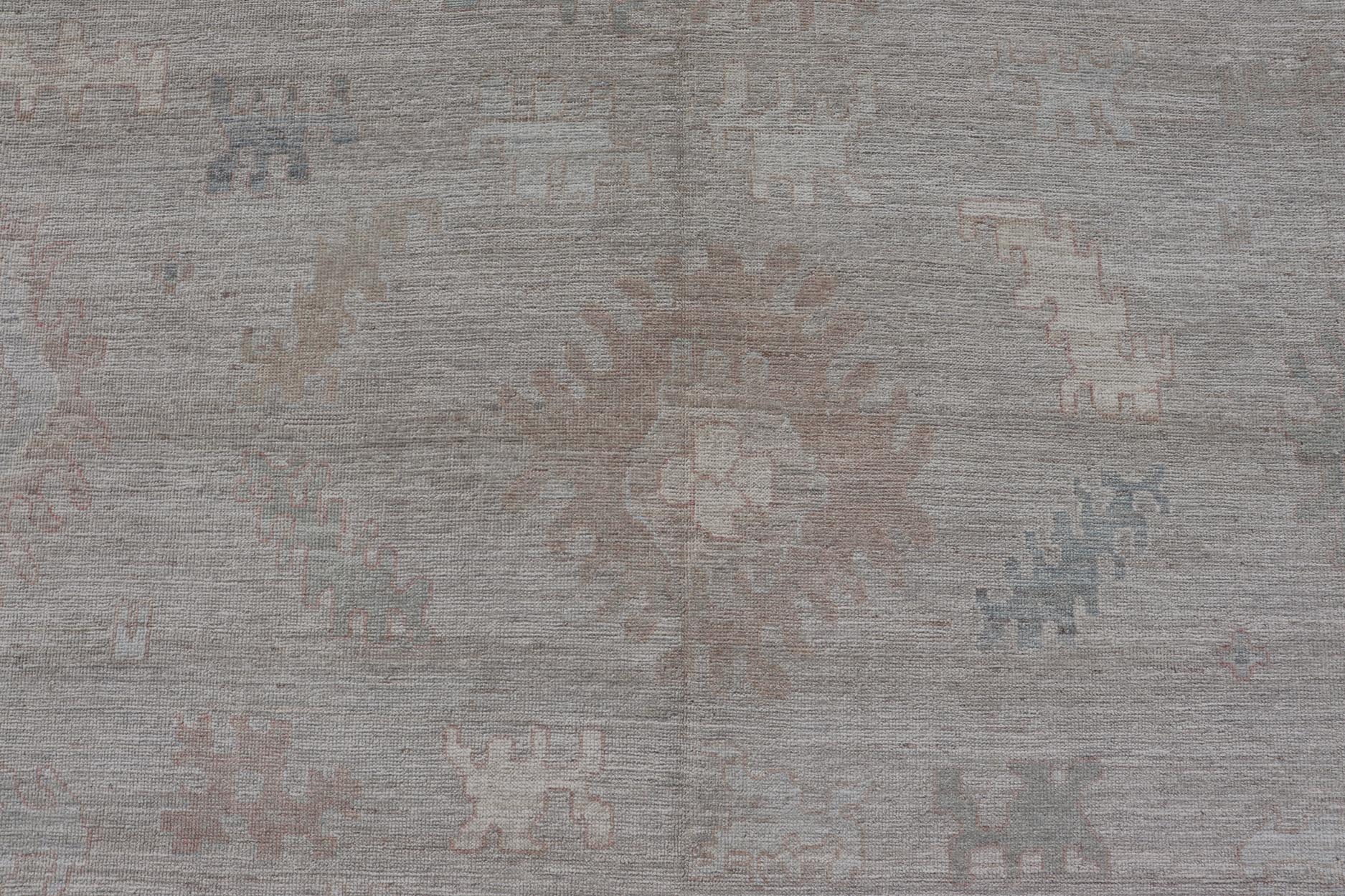 All - Over Floral Modern Oushak with Light Tan Background and Cream Border. Keivan Woven Arts rug AWR - 17919 Country of Origin: Afghanistan Type: Oushak Design: Floral, all - over, abstract floral. Measures: 10'1 x 13'10 This Oushak was hand knotted ... - Keivan Woven ArtsAWR - 17919 - 25078Rug