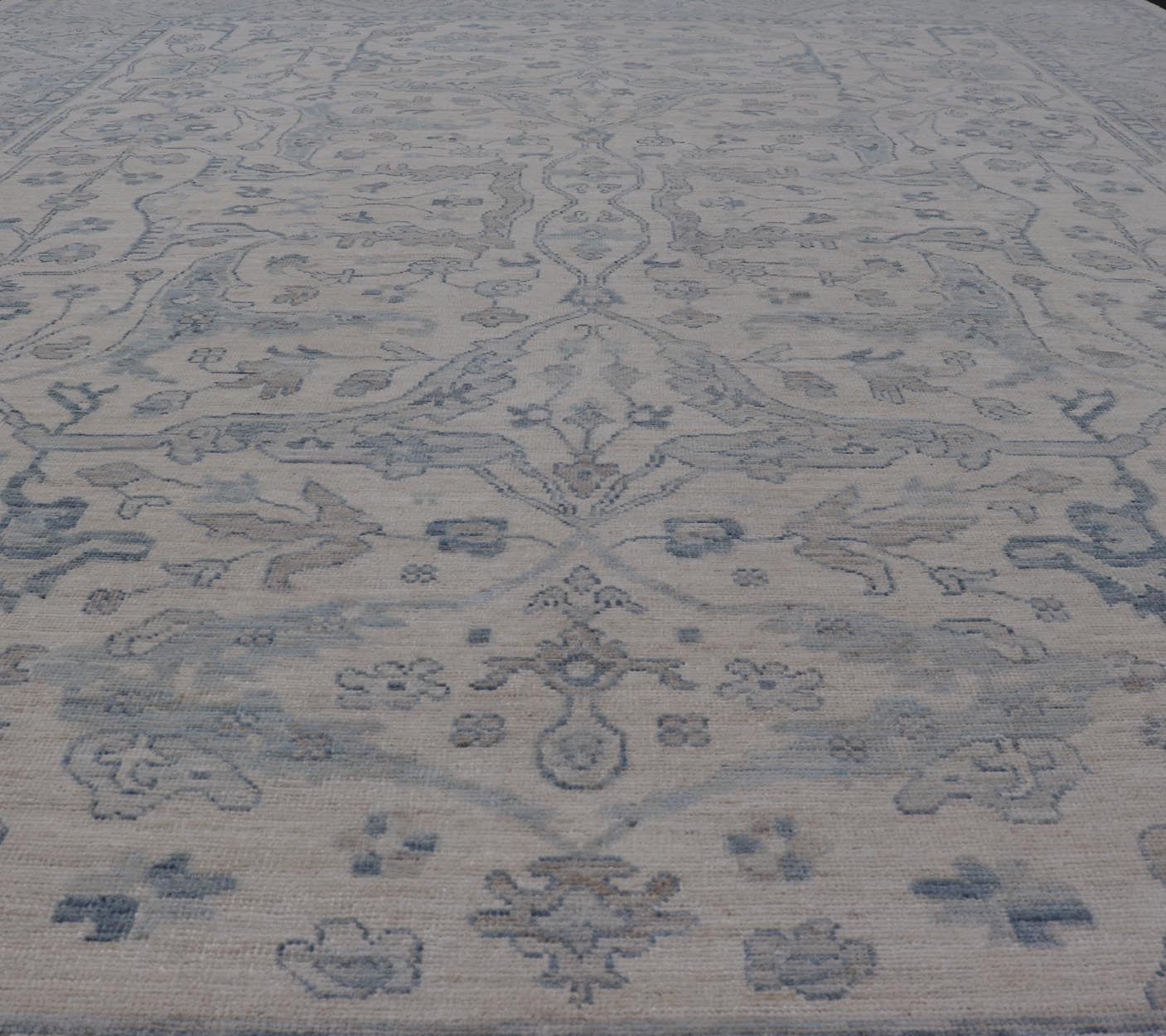 Measures: 10'6 x 14'0 Keivan Woven Arts Modern Oushak on Light Cream Background and Blue Design. Keivan Woven Arts; rug AWR - 355 Country of Origin: Afghanistan Type: Oushak Design. The border and field are covered in floral - like motifs filled wit... - Keivan Woven ArtsAWR - 355 - 27442Rug