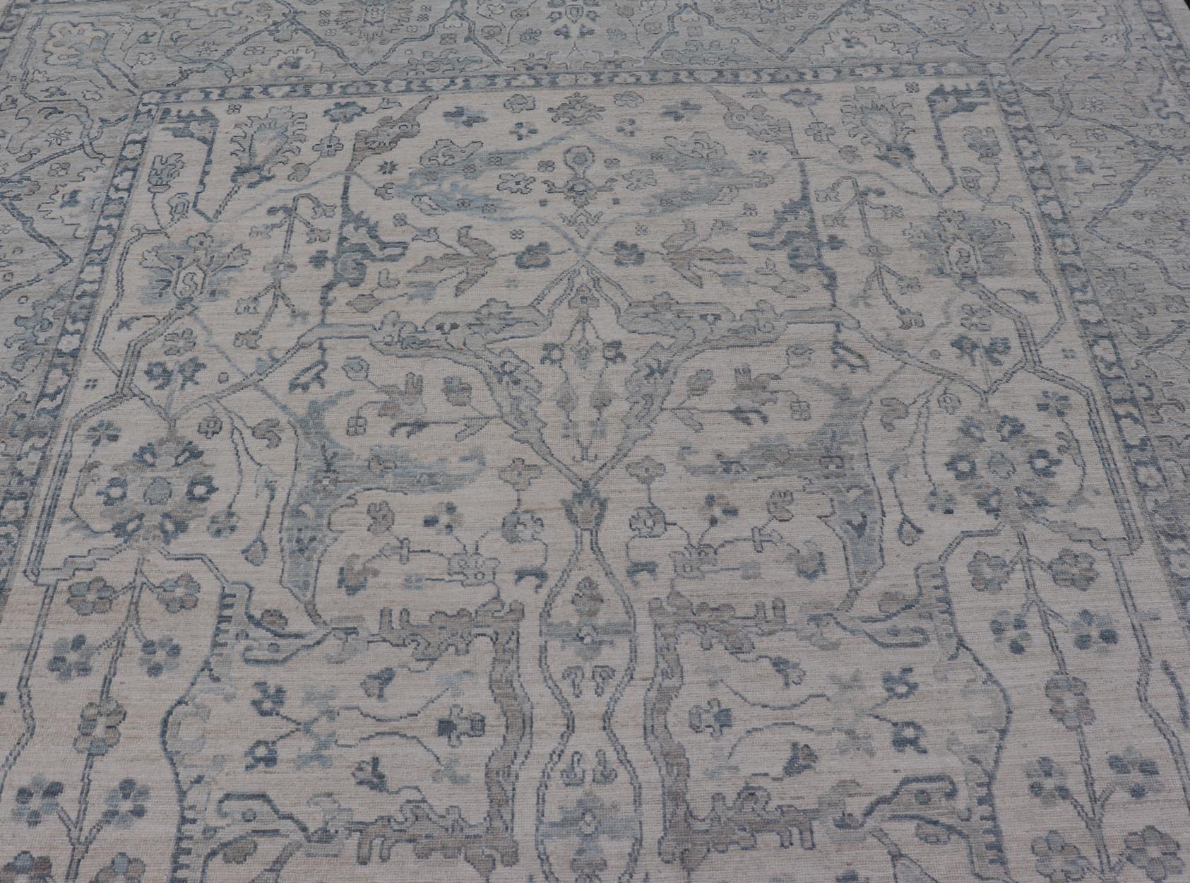 Measures: 10'6 x 14'0 Keivan Woven Arts Modern Oushak on Light Cream Background and Blue Design. Keivan Woven Arts; rug AWR - 355 Country of Origin: Afghanistan Type: Oushak Design. The border and field are covered in floral - like motifs filled wit... - Keivan Woven ArtsAWR - 355 - 27442Rug