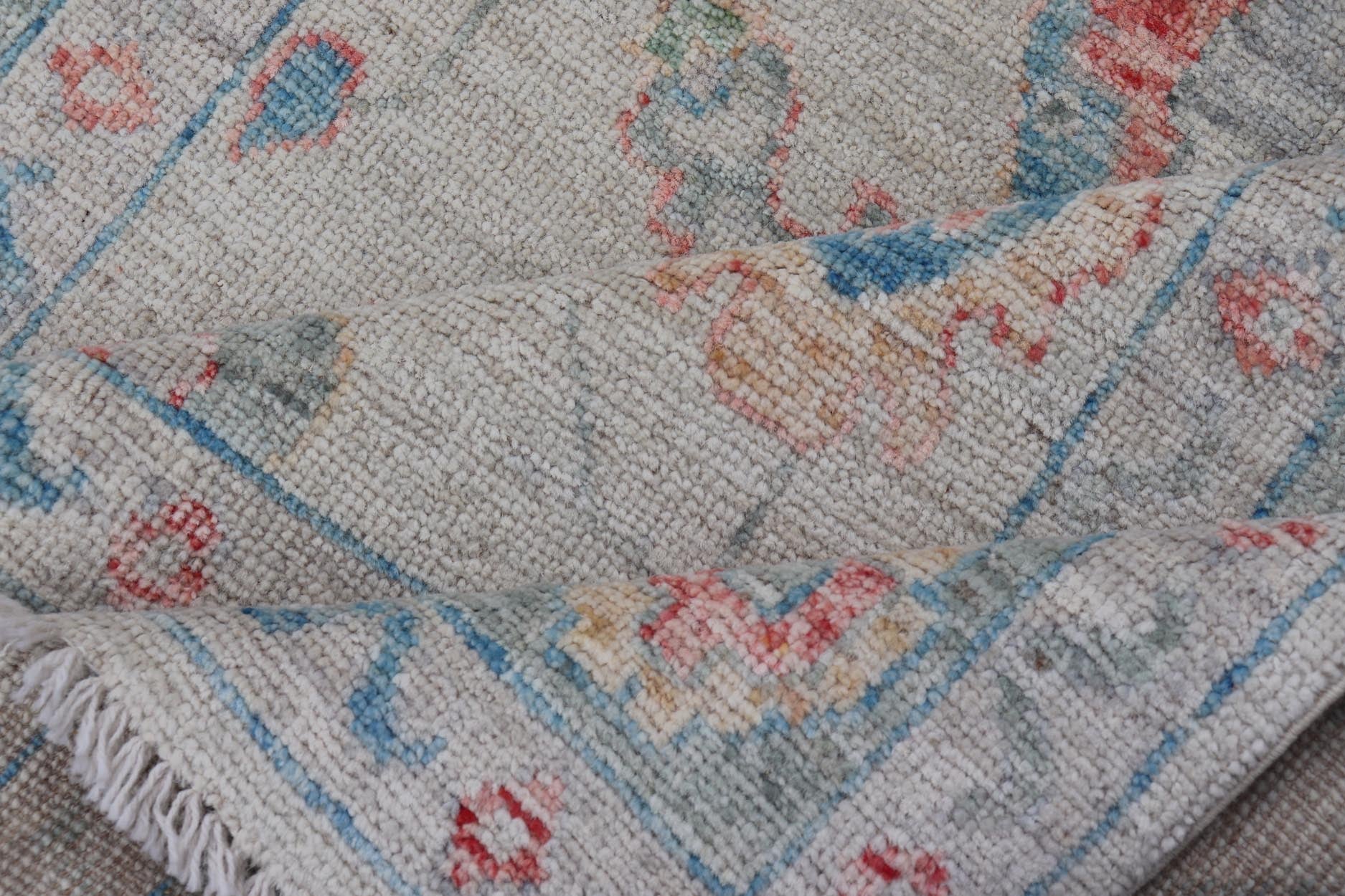 Modern All - Over Floral Oushak with Muted Background and Accent Colors Modern Oushak featuring an all - over, arabesque - like floral design, rendered in saturated oceanic blue, gold, green, red, and red - orange. The background is rendered in a co... - Keivan Woven ArtsAWR - 356 - 19959Rug