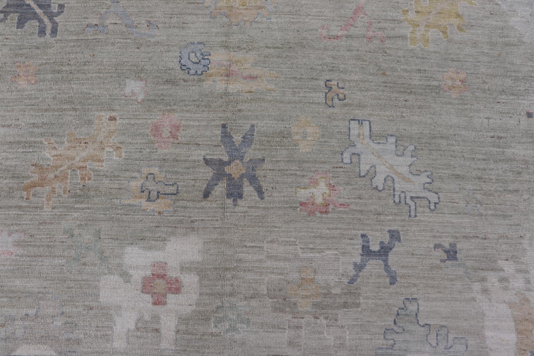 Measures: 12'1 x 17'10 Modern Large Oushak by Keivan Woven Arts with Floral Motifs. Keivan Woven Arts; rug AWR - 405 Country of Origin: Afghanistan Type: Oushak Design. This large Oushak has a border and background that are covered in floral - l... - Keivan Woven ArtsAWR - 405 - 27454Rug