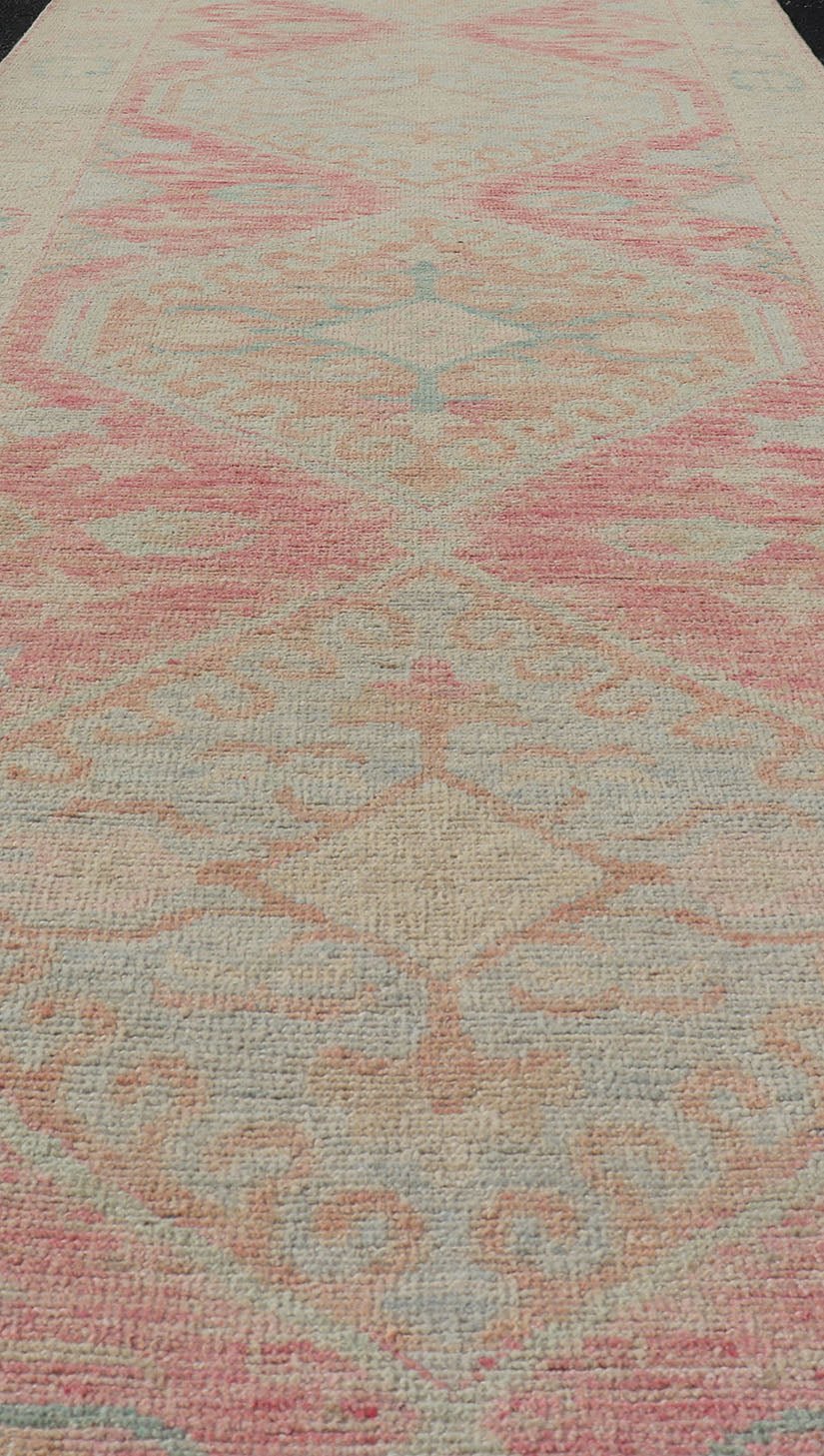 Modern Hand Knotted Oushak Runner With Medallions in Pink's and Creams. Keivan Woven Arts; AWR - 4982 Country of Origin: Afghanistan Type: Oushak Design: Tribal, Measures: 3'0 x 12'9 This long Oushak runner has a light pink background with ... - Keivan Woven ArtsAWR - 4982 - 17136Rug