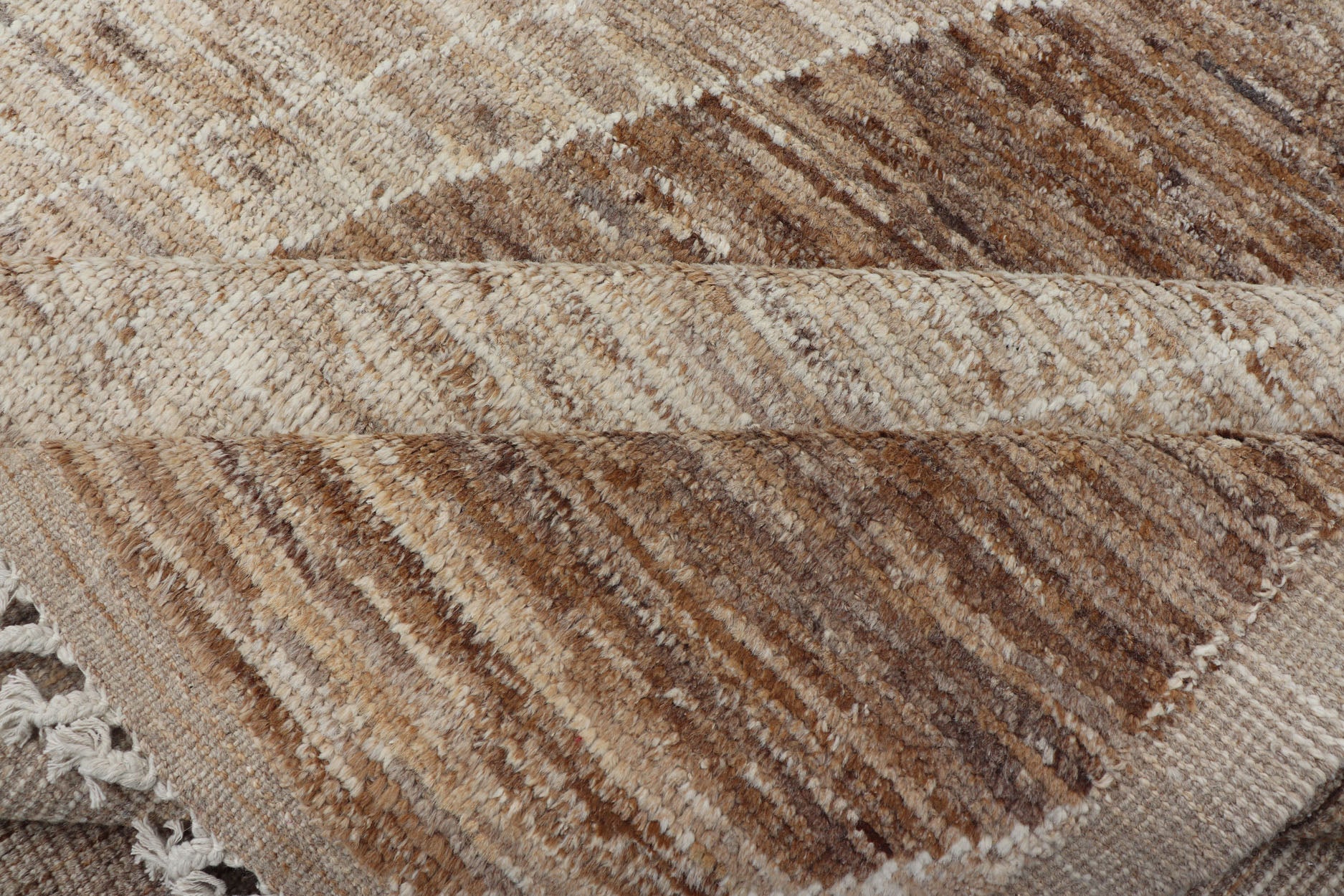 Measures: 10'6 x 14'1. This modern casual tribal rug has been hand - knotted in wool. The rug features a large modern diamond design, rendered in brown, tan, and cream; making this rug a superb fit for a variety of interiors. Modern Hand - Knotted Ru... - Keivan Woven ArtsAWR - 5004 - 17148Rug