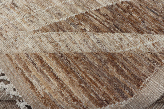 Measures: 10'6 x 14'1. This modern casual tribal rug has been hand - knotted in wool. The rug features a large modern diamond design, rendered in brown, tan, and cream; making this rug a superb fit for a variety of interiors. Modern Hand - Knotted Ru... - Keivan Woven ArtsAWR - 5004 - 17148Rug