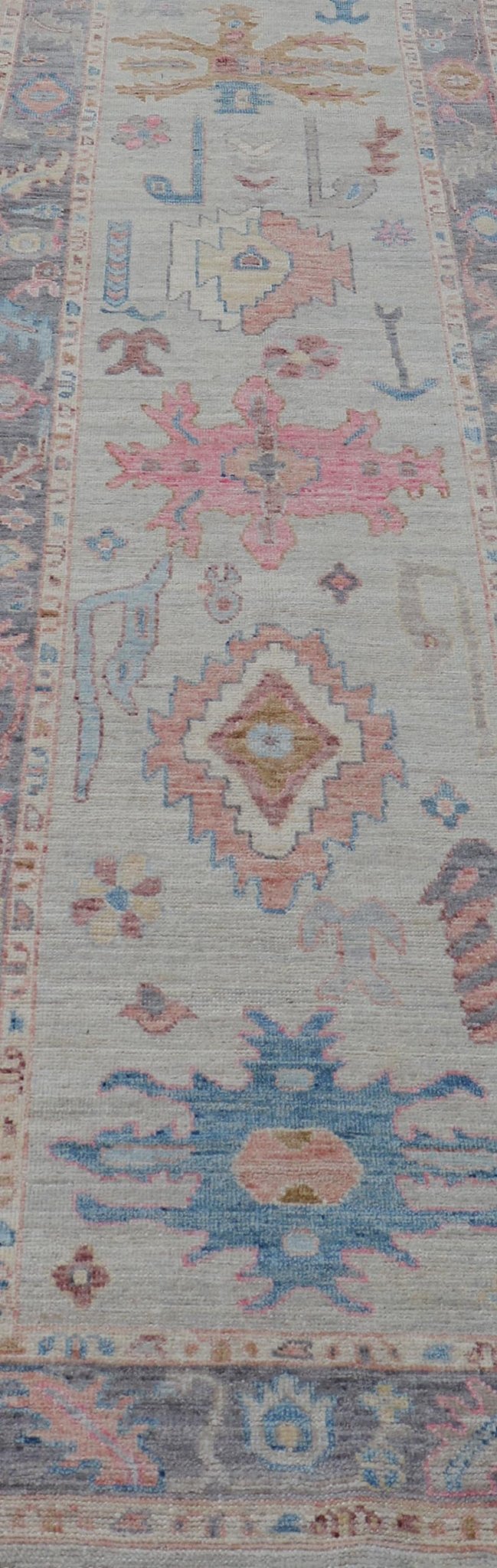Hand - Knotted Modern Tribal Oushak Long Runner in Wool with Colorful Motifs This long Oushak runner has a cream background with a light gray border. The border has a leaflet - like design is rendered in green, coral, and blue with a hint of ye... - Keivan Woven ArtsAWR - 6026 - 19965Rug