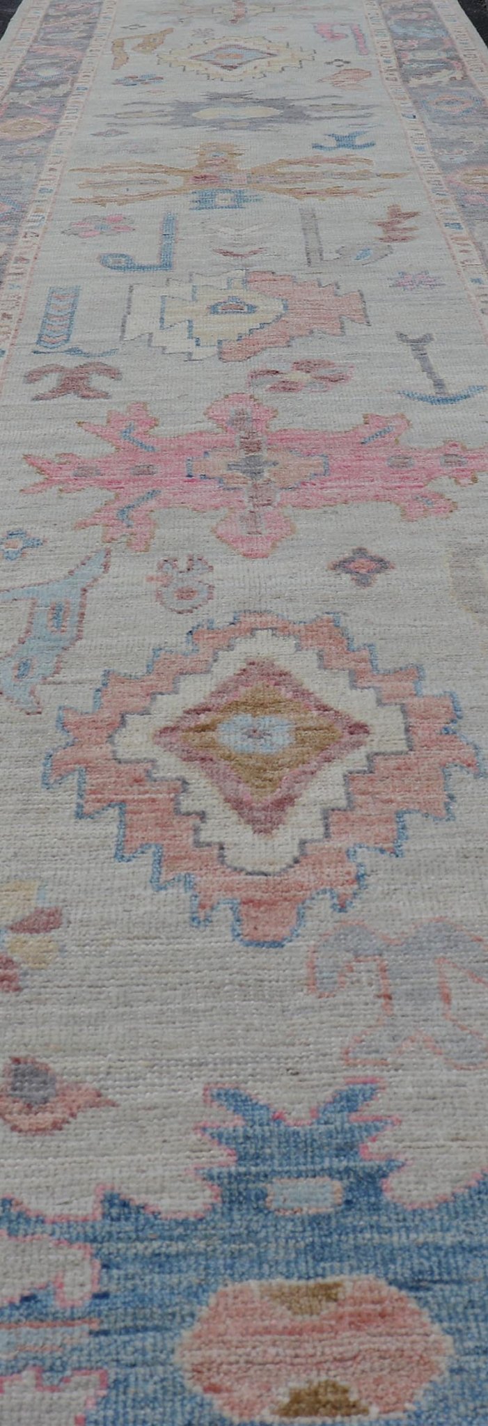 Hand - Knotted Modern Tribal Oushak Long Runner in Wool with Colorful Motifs This long Oushak runner has a cream background with a light gray border. The border has a leaflet - like design is rendered in green, coral, and blue with a hint of ye... - Keivan Woven ArtsAWR - 6026 - 19965Rug