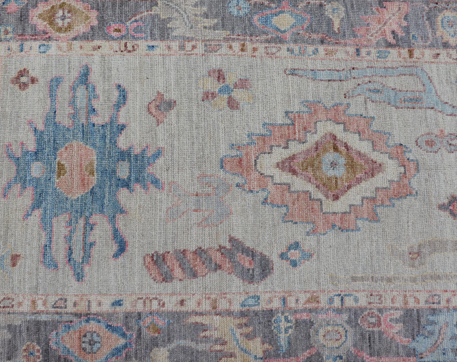 Hand - Knotted Modern Tribal Oushak Long Runner in Wool with Colorful Motifs This long Oushak runner has a cream background with a light gray border. The border has a leaflet - like design is rendered in green, coral, and blue with a hint of ye... - Keivan Woven ArtsAWR - 6026 - 19965Rug