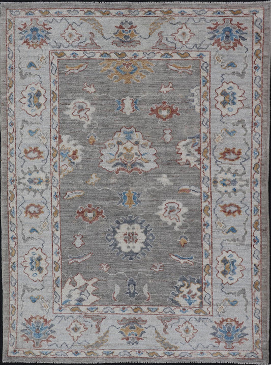 Floral Designed Oushak with Muted Background With Earthy Tones and Soft Blue Modern Oushak featuring an all - over, arabesque - like floral design. The background is rendered in a light gray, while the border is s light pewter blue. The design d... - Keivan Woven ArtsAWR - 6028 - 19971Rug