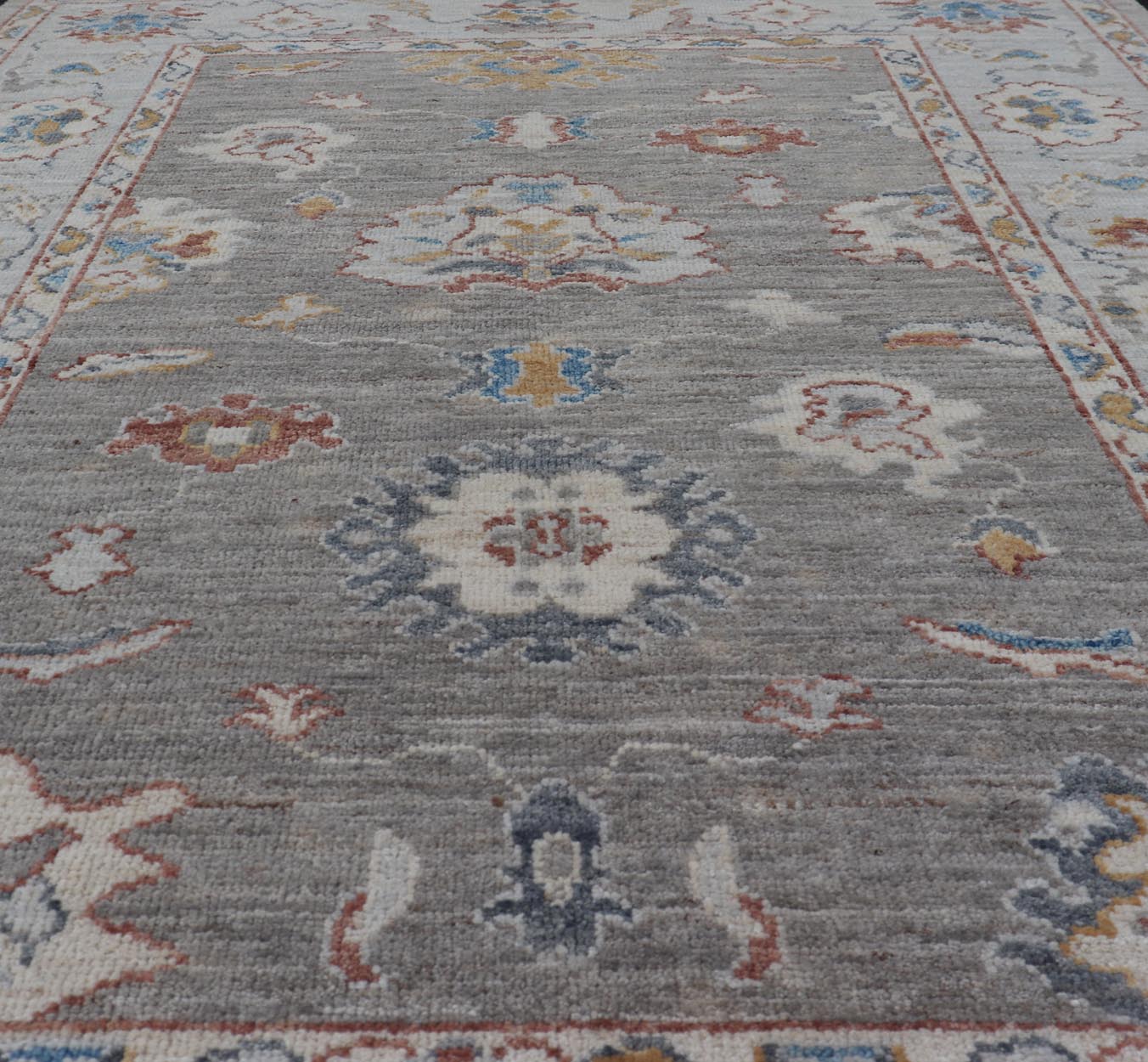 Floral Designed Oushak with Muted Background With Earthy Tones and Soft Blue Modern Oushak featuring an all - over, arabesque - like floral design. The background is rendered in a light gray, while the border is s light pewter blue. The design d... - Keivan Woven ArtsAWR - 6028 - 19971Rug