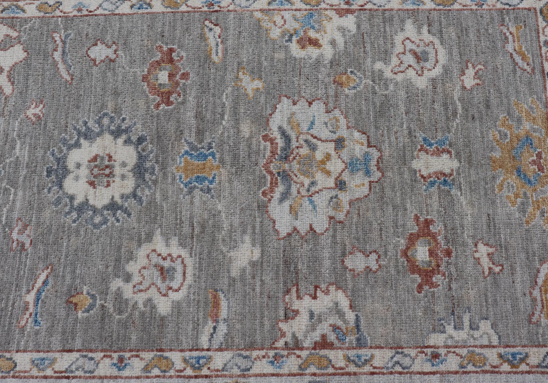 Floral Designed Oushak with Muted Background With Earthy Tones and Soft Blue Modern Oushak featuring an all - over, arabesque - like floral design. The background is rendered in a light gray, while the border is s light pewter blue. The design d... - Keivan Woven ArtsAWR - 6028 - 19971Rug